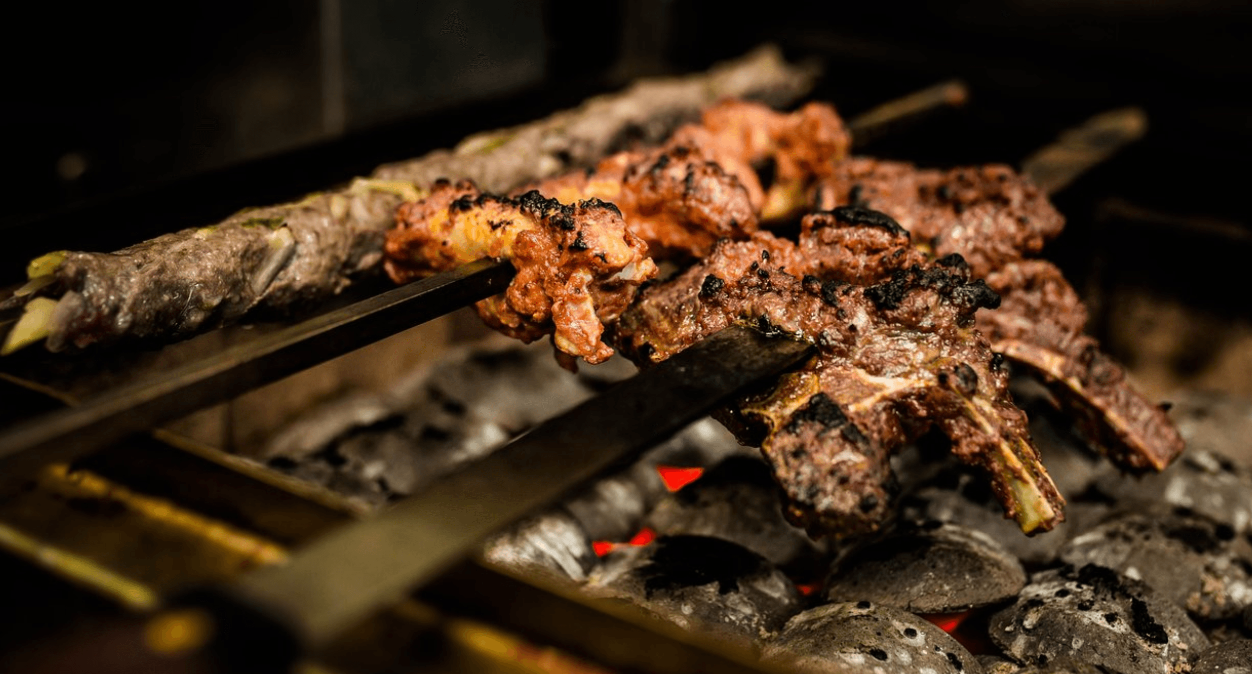 Meat cooking on the grill at Jinnah Bistro