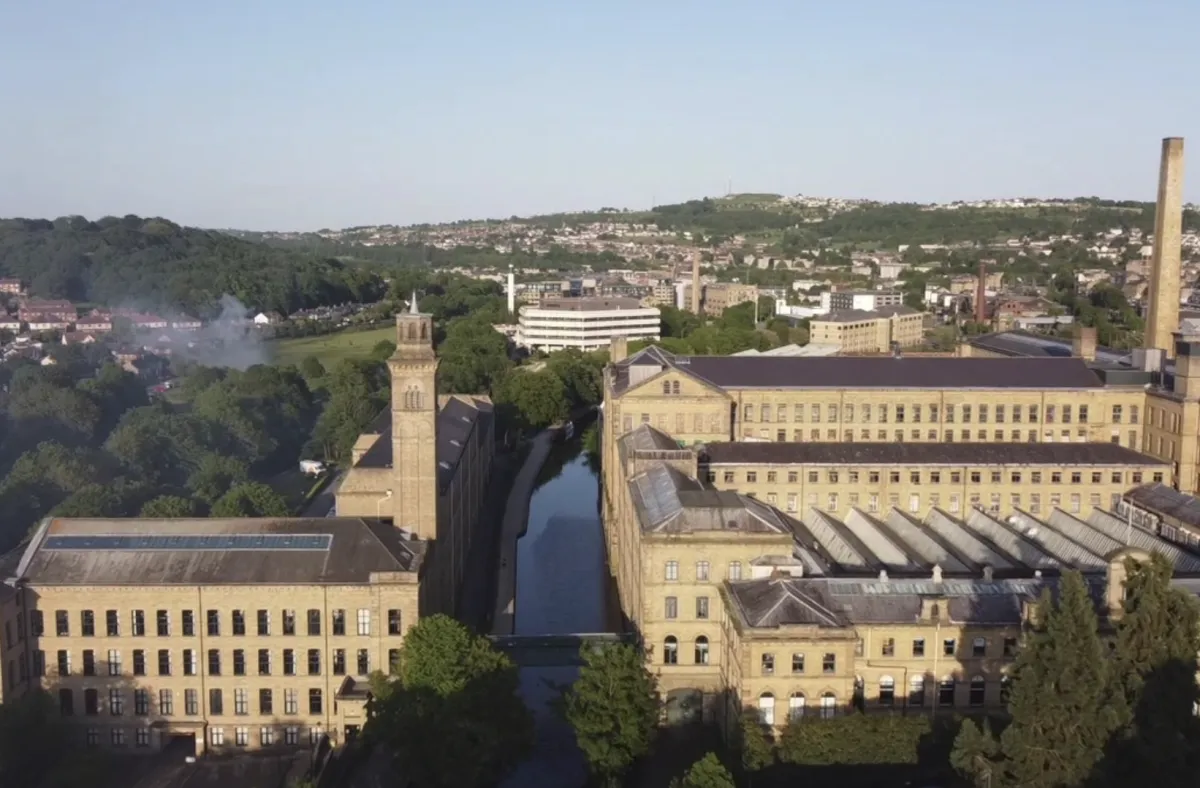 Historic mill building with tall chimney