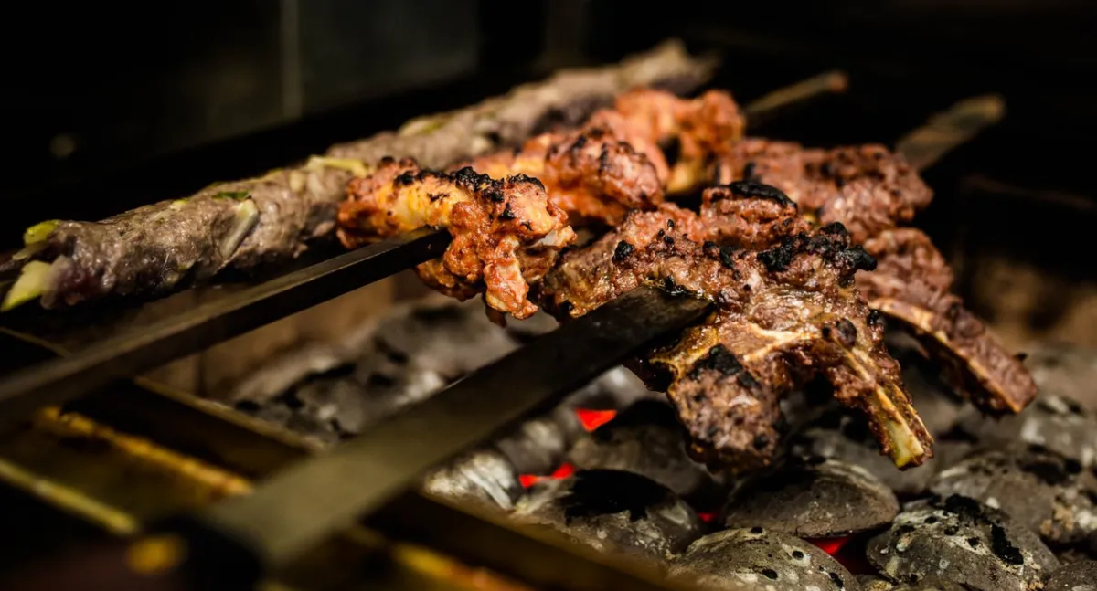 Meat cooking on the grill at Jinnah Bistro